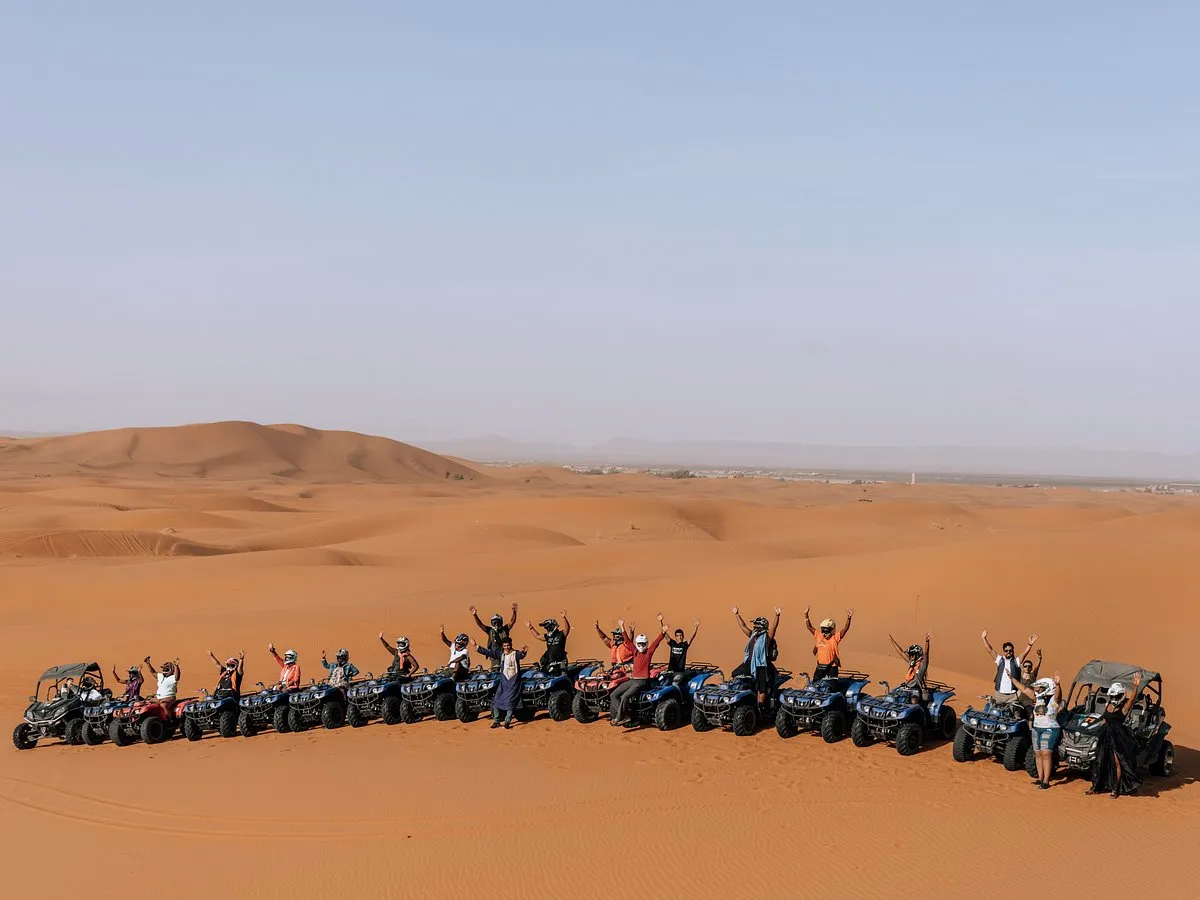 Large group lined up on quad bikes and buggies in the Merzouga dunes