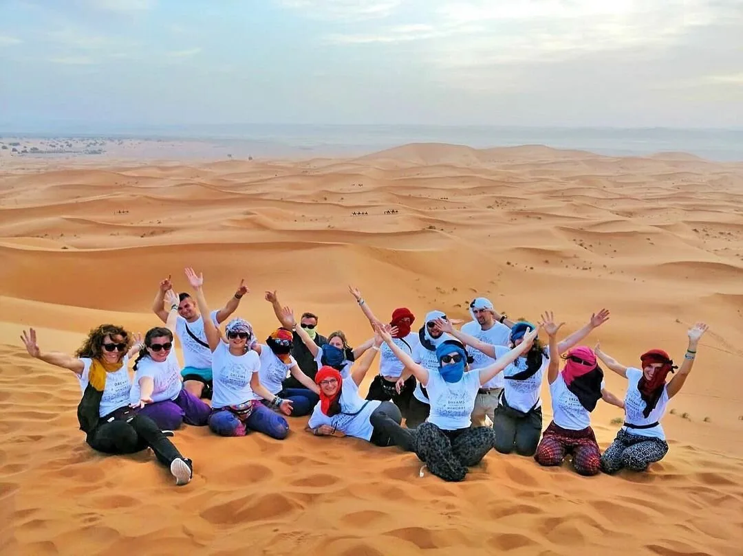 Student group sitting on the Erg Chebbi dunes near Merzouga