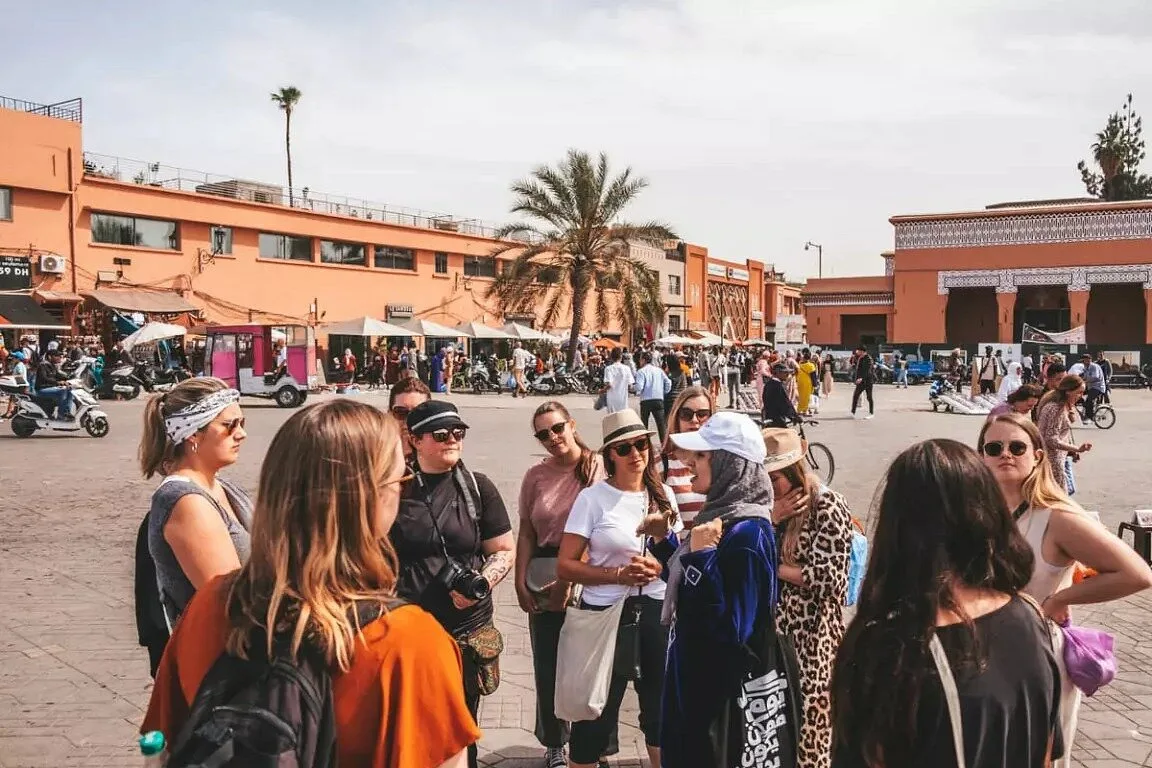 Student group with a local guide on a square in the Marrakech medina