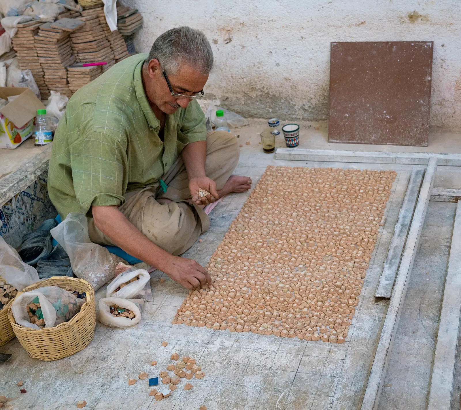 Craftsman setting zellige tiles in Fes