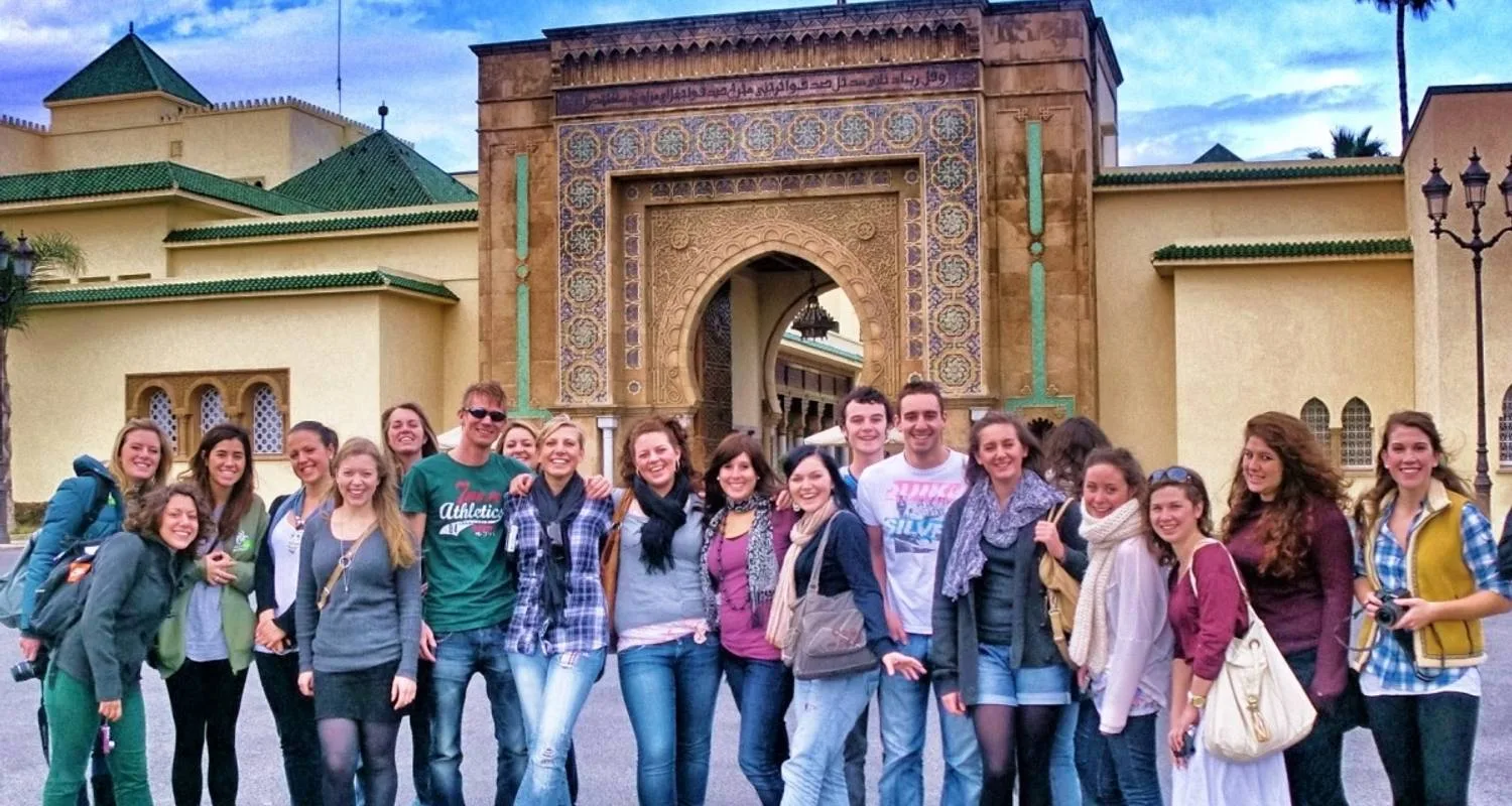 University group in front of an ornate mosque gate in Morocco
